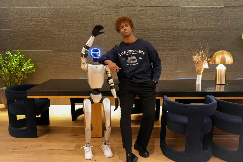 Image Courtesy: Public Domain : Series CEO Nathaneo Johnson with his CMO Robot, Uri.